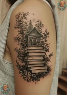 a woman's arm with books and flowers on it, in the shape of a house