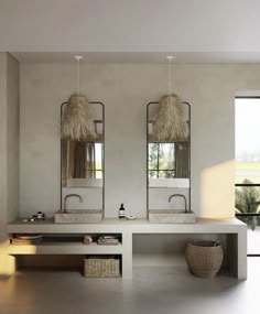 a bathroom with two sinks and mirrors on the wall