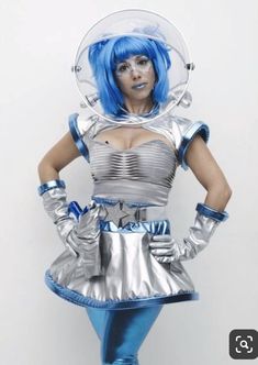 a woman dressed in silver and blue is posing