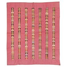 a pink quilted wall hanging with many different designs on it's edges and sides