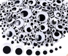 a pile of black and white eyeballs sitting on top of each other