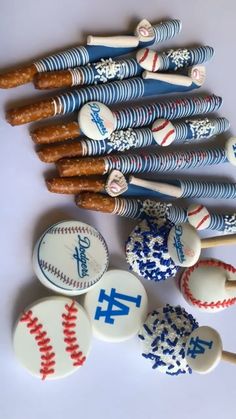 baseball themed cookies and candy sticks on a table