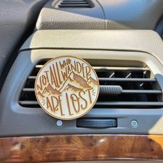 an air vent in the dashboard of a car that says not all who wander are lost