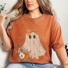 Product Description: Halloween Lacey Ghost with a Bow Comfort Colors Tee Add a touch of spooky elegance to your Halloween wardrobe with this enchanting Comfort Colors tee, featuring a delicate lacey ghost adorned with a charming bow. This unique design captures the perfect blend of eerie and chic, making it an ideal choice for Halloween enthusiasts with a flair for fashion. Crafted from 100% ring-spun US cotton, this tee offers unparalleled comfort with its soft-washed, garment-dyed fabric. The Clothing Recycling, Lace Ghost, Upcycling Shirts, Applique Shapes, Girly Ghost, Handmade Games, Coquette Halloween, Ghost Tee, Upcycle Ideas