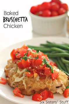 chicken with tomatoes and green beans on a white plate