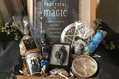 a box filled with assorted items sitting on top of a table next to a book