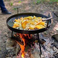 food is being cooked over an open fire