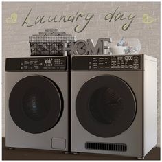 two washers sitting side by side in front of a brick wall with the words laundry day on it