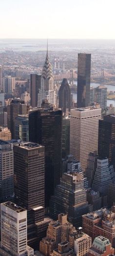 an aerial view of new york city with skyscrapers in the foreground and empire building on the far side