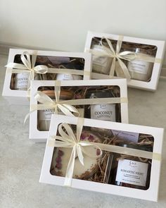 three white boxes filled with different types of chocolates