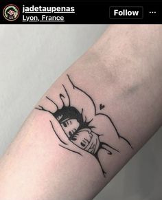 a tattoo on the arm of a person with a fist bumping it's head