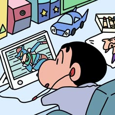 a man laying in bed next to a laptop computer with cartoon characters on the screen