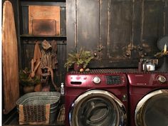 a washer and dryer in a room with wood paneling on the walls