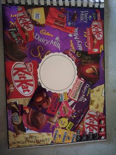 a spiral notebook covered in various candy and chocolates, with the word dairy milk printed on it