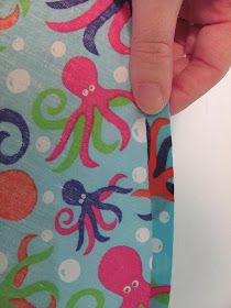 a hand holding onto an octopus print fabric