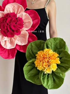 a woman holding two fake flowers in her hands