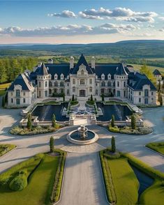 an aerial view of a large mansion in the countryside