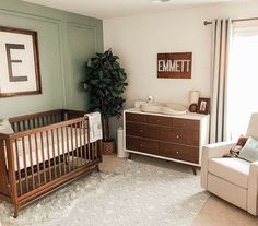 a baby's room with a crib, dresser and chair