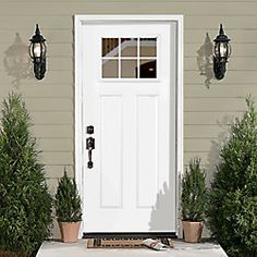 a white front door on a house with potted plants and two hanging lights next to it