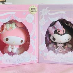 two hello kitty figurines are shown in the same box as they appear in this photo