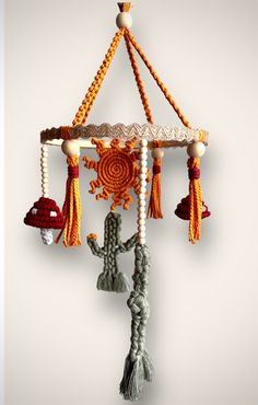 a wind chime hanging from the ceiling with beads and tassels on it