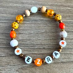 a beaded bracelet with letters that spell out the letter e, z, and a star