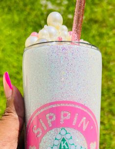 a hand holding a starbucks drink with pink and white sprinkles