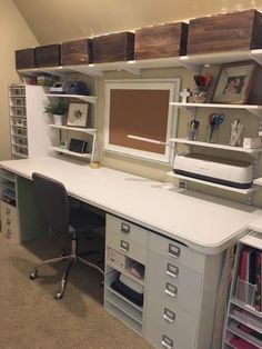 a white desk with drawers and a computer monitor on it's shelf above the desk