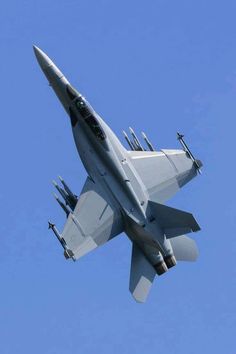 a fighter jet is flying through the blue sky