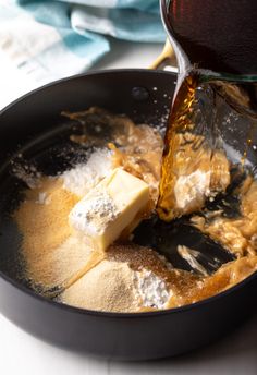 a pan filled with butter and other ingredients being poured into the skillet to make pancakes