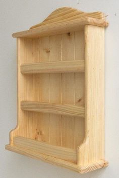 a wooden shelf mounted to the wall with three shelves on one side and two open sides