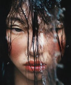 a woman with water on her face and hair