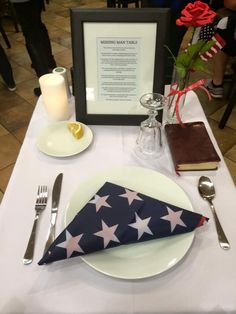 a place setting with an american flag napkin and silverware