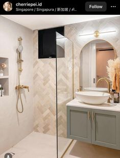 a bathroom with a sink, mirror and shower head in the corner next to it