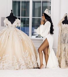 a woman in a white dress is talking on her cell phone next to some mannequins