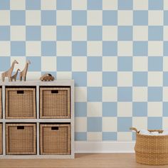 a toy giraffe is sitting on top of a dresser next to some baskets