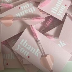 pink thank you notes with hearts and zippers on them are laid out in a pile