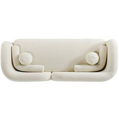 a white couch with two pillows on it's back and one arm facing the camera