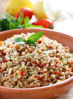 a brown bowl filled with rice and vegetables