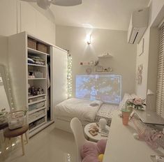 a bedroom with a bed, desk and chair in it's center area next to a closet