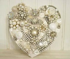 a heart made out of buttons and pearls