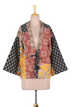 A mixed-print patchwork and kantha embroidery lend a wonderfully bohemian attitude to this kimono-style jacket. Crafted of all cotton the jacket features a front tie and flared sleeves. Designer Jay Kumar Maheshwari presents the jacket which is crafted by local artisans in Jaipur India. Kimono Ideas, Quilted Kimono, Kimono Styles, Asymmetric Blouse, Recycled Kimono, Creating Patterns, Gifts For Travelers, Patchwork Kimono, Wearable Art Clothing