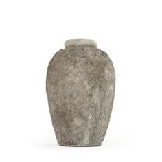 a large gray vase sitting on top of a white table