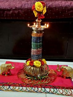 a table topped with lots of different types of decorations and candles on top of it