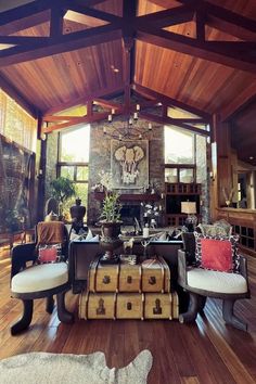 a living room filled with lots of furniture and a fire place in the middle of it