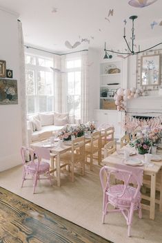 a living room filled with lots of furniture next to a fire place and a dining table