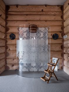 a chair sitting in the middle of a room next to a wall covered in wood