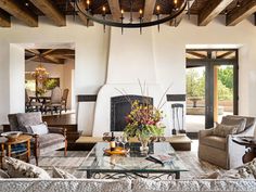 a living room filled with furniture and a fire place in the middle of a room