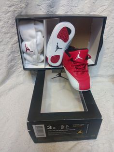 Infant toddler gift pack baby cap hat and shoes are in excellent condition worn a few times kept very clean Elevate your baby's shoe game with these iconic Jordan 12 Retro sneakers. Featuring a red, white, and black colorway and the famous Michael Jordan logo, these lace-up sneakers are perfect for any occasion, whether it's a casual day out or some light activity. Made of synthetic leather and foam, these shoes are durable and comfortable for your little one's feet. These sneakers are part of t