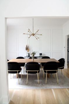 a dining room table with chairs and a chandelier